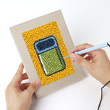 Punching a Yellow Sundae Glass mini canvas with the punch needle