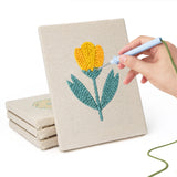 Hand punching one of the Yellow Tulip Patch mini canvases