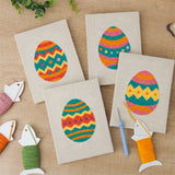The four finished Zigzag Easter Eggs mini canvases laid out on a table